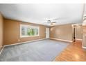 Spacious living room with neutral carpet, large window, and hardwood entryway at 5079 S Lick Creek Rd, Morgantown, IN 46160