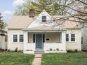 Inviting one-story home featuring a quaint front porch and cheerful curb appeal at 5252 N College Ave, Indianapolis, IN 46220