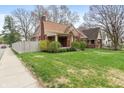 A charming home with well-manicured lawn and beautiful, mature trees at 5697 Broadway St, Indianapolis, IN 46220