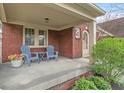 Inviting front porch with seating, perfect for relaxing and enjoying the outdoors at 5697 Broadway St, Indianapolis, IN 46220