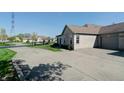 A well-maintained home with a paved driveway and manicured lawn at 5839 Quail Run Dr, Indianapolis, IN 46237
