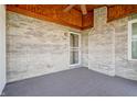 A covered outdoor patio with brick wall, a fan, and outdoor carpet at 5839 Quail Run Dr, Indianapolis, IN 46237