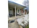 Cozy covered porch with comfortable seating offers a welcoming entrance to the home at 6011 Mcclellan Ct, Indianapolis, IN 46254