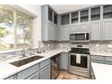 Charming kitchen featuring stainless steel appliances, countertop, and tile backsplash at 6164 Parrington Dr, Indianapolis, IN 46236