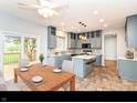 Bright kitchen with updated appliances, tile flooring, a center island, and breakfast nook near sliding glass door at 6164 Parrington Dr, Indianapolis, IN 46236