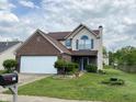 Charming two-story home with brick and vinyl siding, manicured lawn and mailbox at 621 Jack Pine Ct, Indianapolis, IN 46224