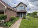 View of a charming home's front entrance with a well-maintained yard and walkway at 621 Jack Pine Ct, Indianapolis, IN 46224