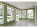 Bright sunroom featuring large windows, neutral paint, and ample natural light at 6307 Broadway St, Indianapolis, IN 46220