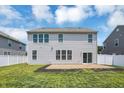 Back exterior of the house showing the patio, well-maintained lawn, and white vinyl fence at 6827 Fallen Leaf Dr, Whitestown, IN 46075