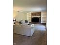 Comfortable living room showcasing a brick fireplace, built-in shelving, and access to the backyard at 7140 Avalon Trail Dr, Indianapolis, IN 46250