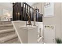 Staircase featuring carpeted steps, dark wooden railing, and decorative touches at 9014 Ramapo Dr, Fishers, IN 46038
