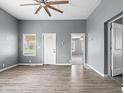 Open-concept living room with wood floors, a ceiling fan, and neutral paint at 917 S Grant St, Muncie, IN 47302
