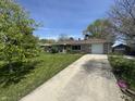 Attractive ranch home boasting a long driveway and well-manicured front lawn at 1021 N Bolton Ave, Indianapolis, IN 46219