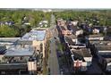 Aerial view showcasing the community's street, sidewalks, and landscaping on a sunny day at 11 Woodacre Dr, Carmel, IN 46032