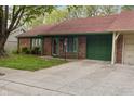 Charming single-story brick home with a well-maintained lawn, red roof, and green trim at 11 Woodacre Dr, Carmel, IN 46032