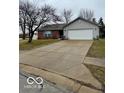 View of home exterior with a large driveway and well-maintained lawn at 1102 Branifield Ct, Franklin, IN 46131