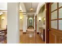 Charming hallway features hardwood floors, paneled walls, and decorative lighting fixtures at 12010 Landover Ln, Fishers, IN 46037