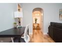 Bright home office with modern desk, chair, and hardwood floors flowing into the dining area at 1209 N Downey Ave, Indianapolis, IN 46219