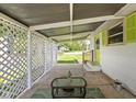 Inviting covered patio with cozy seating, perfect for outdoor relaxation and entertaining at 1212 N 10Th St, Elwood, IN 46036
