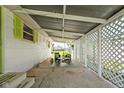 Relaxing covered patio area with outdoor seating and lattice privacy screens at 1212 N 10Th St, Elwood, IN 46036