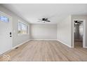 Bright living room with light-colored walls, new vinyl floors, ceiling fan, and ample natural light at 1243 N Post Rd, Indianapolis, IN 46219