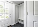 Mud room featuring hexagon tile flooring and built-in shelving for easy organization and storage at 12577 Pointer Pl, Fishers, IN 46038