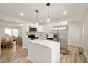 Modern kitchen featuring stainless steel appliances, white cabinetry and a center island at 1295 Rolling Ridge Dr, Noblesville, IN 46060