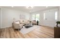 Bright living room featuring hardwood floors, neutral decor, and ample natural light at 1295 Rolling Ridge Dr, Noblesville, IN 46060