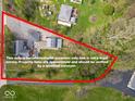 Aerial view highlighting property lines, house, detached garage, and surrounding green space at 1394 N Michigan Rd, Shelbyville, IN 46176