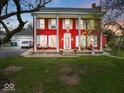 Charming red two-story home with white columns and shutters, exuding classic curb appeal at 1394 N Michigan Rd, Shelbyville, IN 46176