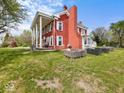 Rear exterior view of home with large yard and detached garage at 1394 N Michigan Rd, Shelbyville, IN 46176