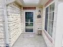 Inviting entryway with stone accents, a glass-paned door and address plaque at 16924 Maple Springs Way, Westfield, IN 46074