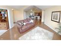 Cozy living room with hardwood floors, a comfortable brown leather sofa and natural light at 16924 Maple Springs Way, Westfield, IN 46074