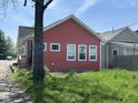 The side view of a cozy one-story home with a simple yard and view of the neighbor's house at 1824 Spann Ave, Indianapolis, IN 46203