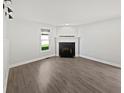 Living room featuring wood floors, a fireplace, and lots of natural light at 2080 Norwich Pl, Martinsville, IN 46151