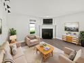 Bright living room features a fireplace, neutral decor, and wood-look floors at 2080 Norwich Pl, Martinsville, IN 46151