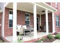 Inviting front porch with comfortable seating, decorative plants, and stylish decor at 2120 Dakota Dr, Franklin, IN 46131