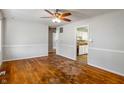 Spacious living room featuring hardwood floors, neutral walls, and doorway view into the kitchen at 219 S Sherman Dr, Indianapolis, IN 46201