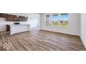 Open-concept kitchen and living space with an island, stainless steel appliances, and lots of natural light at 2257 Aviary Ln, Danville, IN 46122