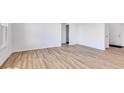 Bright living room with wood flooring, white walls, and large windows providing ample natural light at 2257 Aviary Ln, Danville, IN 46122