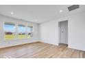 Spacious living room with wood flooring, white walls, and large windows providing ample natural light at 2257 Aviary Ln, Danville, IN 46122