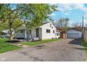 Well-maintained exterior of a single-story home with a private driveway and detached garage at 2539 E 68Th St, Indianapolis, IN 46220