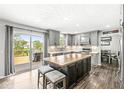Modern kitchen featuring an island with a butcher block countertop, stainless steel appliances, and backyard access at 3582 Fieldhurst Ln, Plainfield, IN 46168