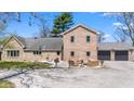 Beautiful home with an outdoor patio with seating, a brick exterior, and a two-car garage at 4155 S State Rd 39, Lebanon, IN 46052