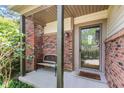 Inviting front porch with brick accents, bench, and a glass-paneled front door at 4322 Matrea More Ct, Indianapolis, IN 46254