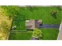 An aerial view of a home with a fenced backyard, a small storage shed and lush green grass at 4525 Shelbyville Rd, Indianapolis, IN 46237