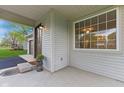 A close-up of the front porch with the front door, a welcome mat and a large window on the side at 4525 Shelbyville Rd, Indianapolis, IN 46237