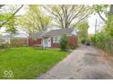 A cozy brick home is complemented by lush greenery and a private driveway at 476 Southgate Dr, Greenwood, IN 46143