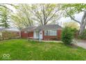 Inviting brick home featuring a well-maintained lawn, classic design, and beautiful mature trees at 476 Southgate Dr, Greenwood, IN 46143