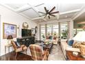 Inviting living room featuring coffered ceilings, dark wood floors, and an abundance of natural light at 5158 Montview Way, Noblesville, IN 46062